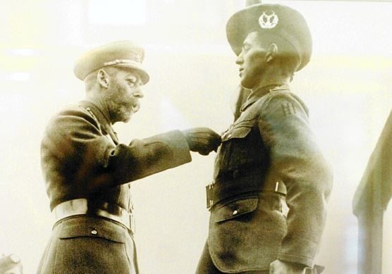 Private George McIntosh being awarded the Victoria Cross by King George V