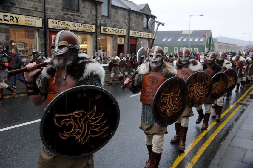 Guizer Jarl Lyall Gair leads his squad through the streets of Lerwick.