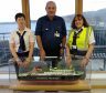 Left to right – Lochmaddy port manager Mary Morrison with port assistant John MacDonald and senior clerk Sandra Rankin together with the MV Hebrides model on the day she arrived