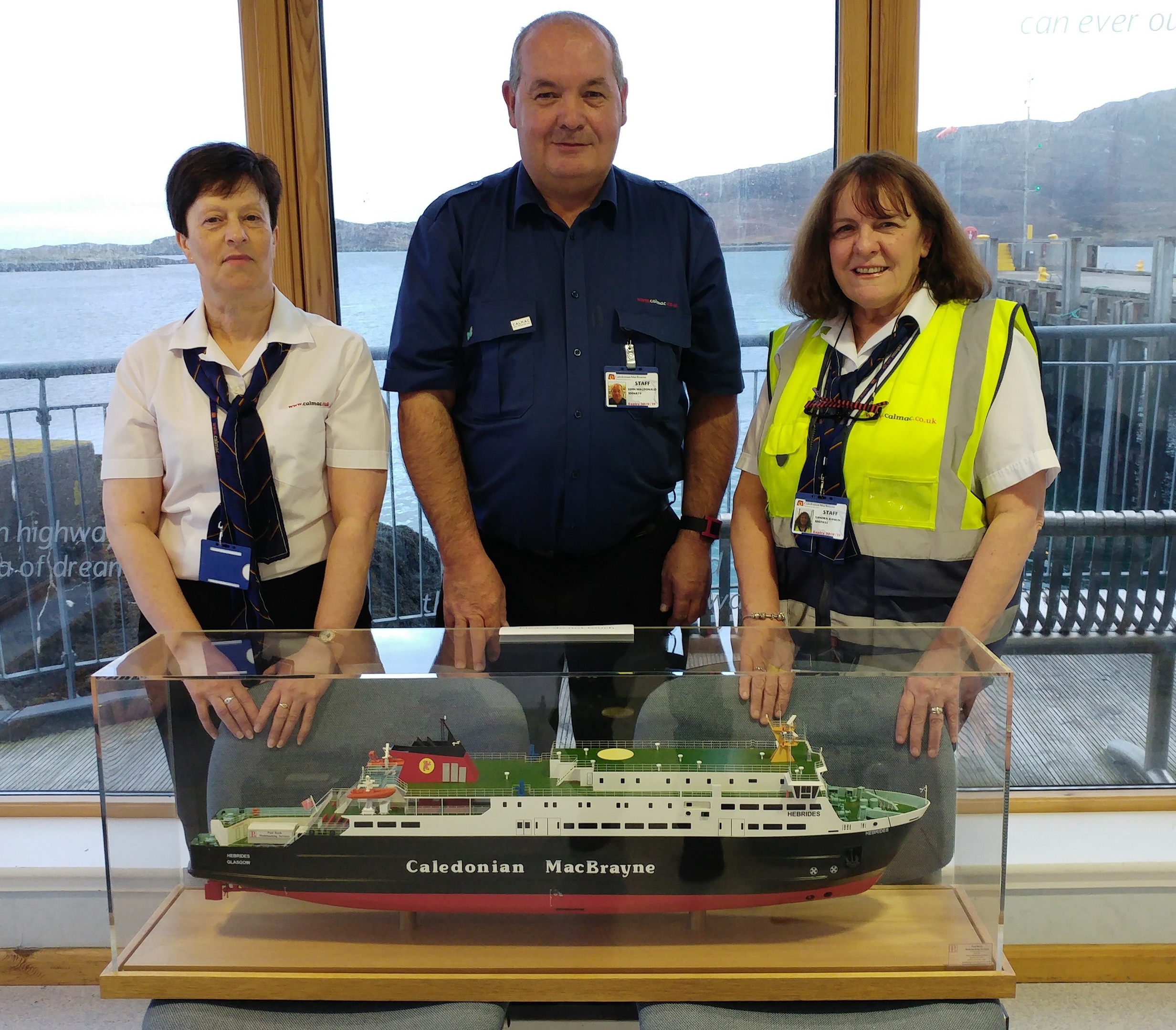 Left to right – Lochmaddy port manager Mary Morrison with port assistant John MacDonald and senior clerk Sandra Rankin together with the MV Hebrides model on the day she arrived