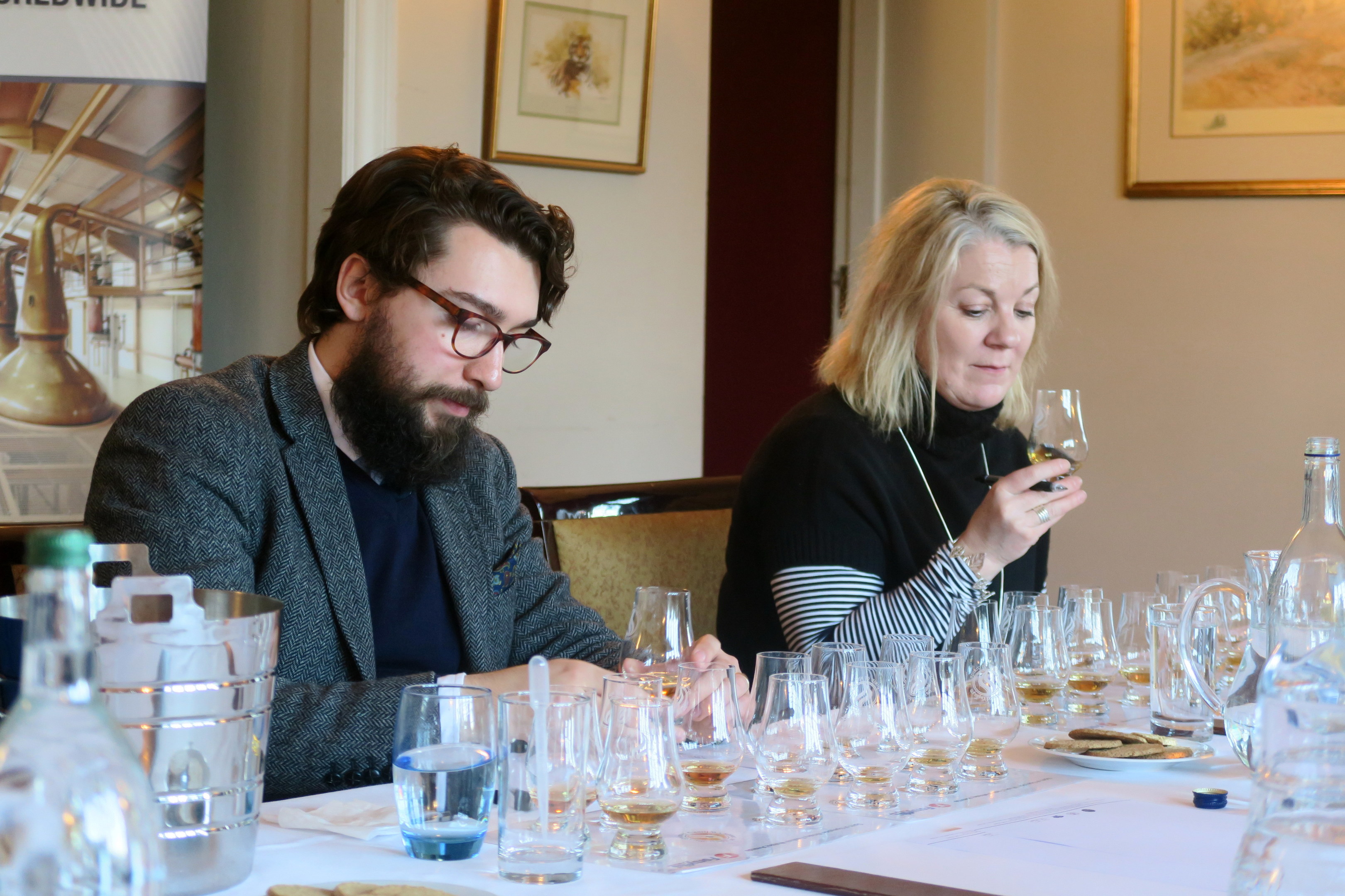 Director of Keepers of the Quaich, Annabel Miekle, and whisky writer Blair Bowman sample the whiskies in the blind tasting as part of the judging panel.
