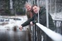 Moray MP Angus Robertson and Graham Ritchie, who caught the first salmon of the season last year, pour whisky into the River Spey to open the new season.