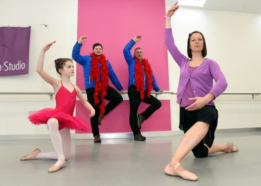 Jemma McRae  with her daughter Izzy and dance volunteers Tom Osborn (left) and John McLain from Shirlaws Motorcycles Ltd.