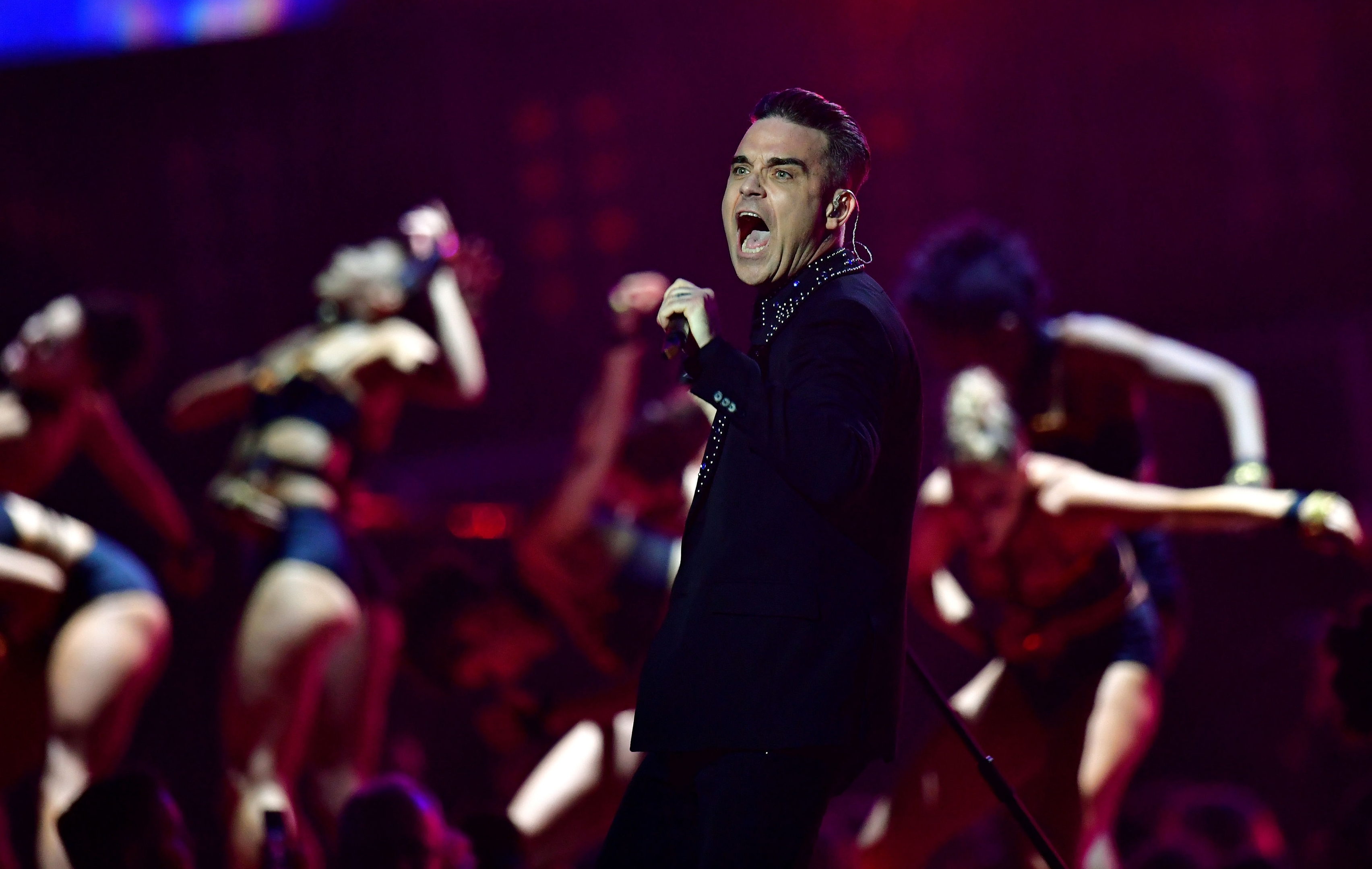 Robbie Williams performs on stage at the Brit Awards at the O2 Arena
