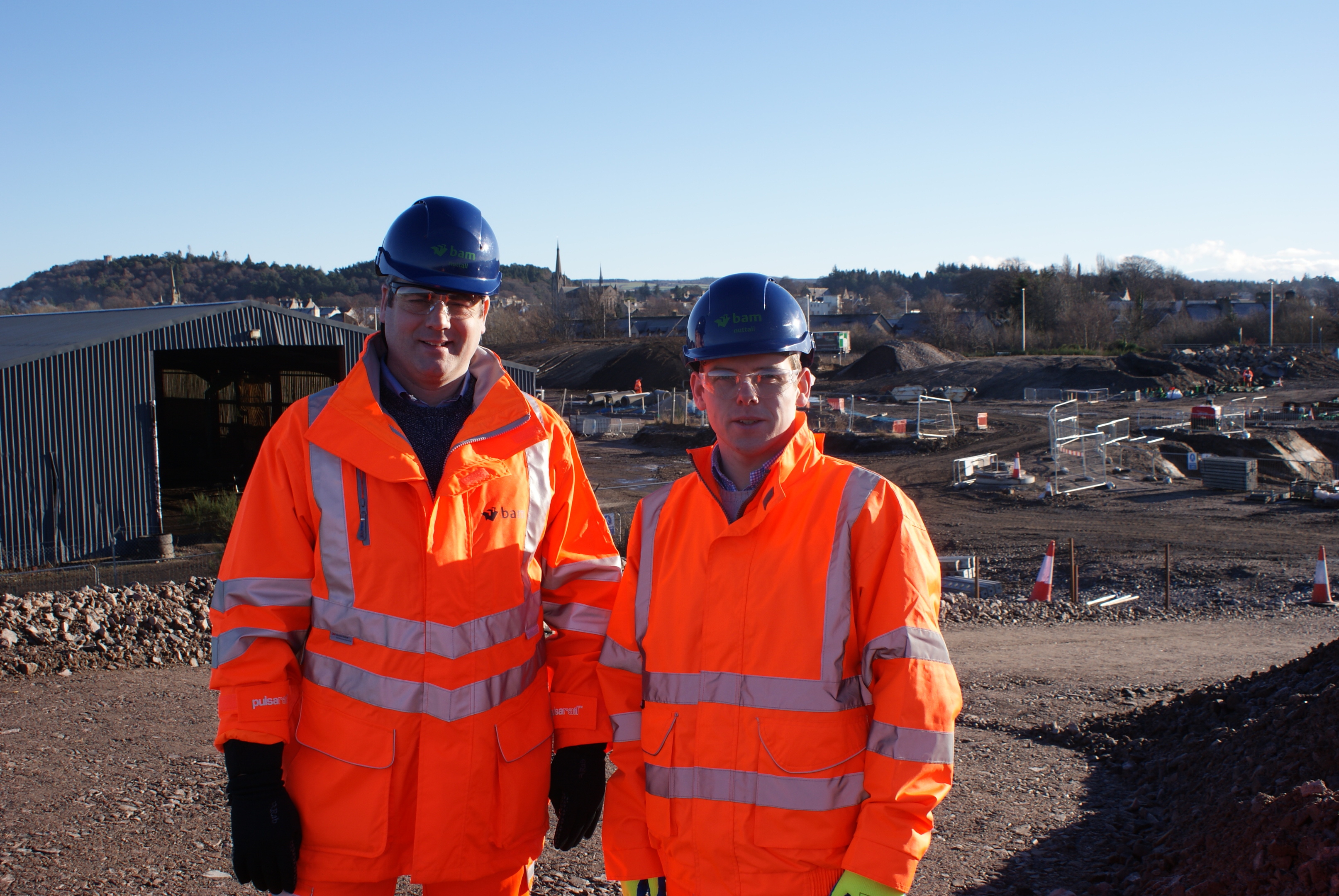 Highlands and Islands MSP Douglas Ross, pictured right, and Stuart MacKay from Bam Nuttal at the building site that will become the new train station for Forres.
