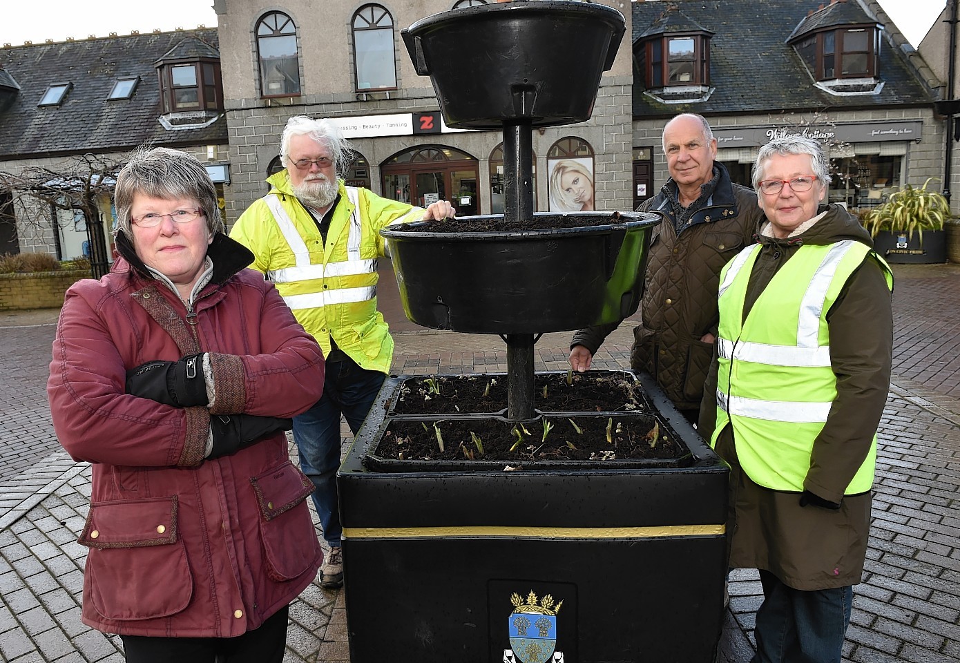 Ellon Civic Pride's planter in Neil Ross Square has been vandalised for the second week in a row. (from left) Frances Watson, Forbes Hamilton, Bill Gibb and Aileen Taylor.
Picture by COLIN RENNIE