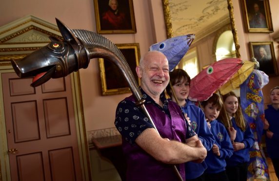Musician John Kenny with a replica of the Deskford Carnyx and pupils from Banff Academy
