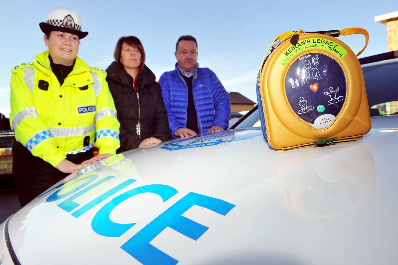 Chief inspector Louise Blakelock with Sandra and Gordon McKandie at the launch of the pilot scheme for defibrillators to be carried in the boot of road policing vehicles.