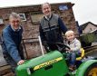 Three year old Alfie Mearns with the toy tractor his grandfather Bob Mearns (centre) made for his dad. Jim Wilson, one of the Men's Shed workers (pictured) did most of the work to refurbish it.
Picture by Colin Rennie.