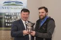 Jake Sayles (right) receives his award from NFUS president Allan Bowie