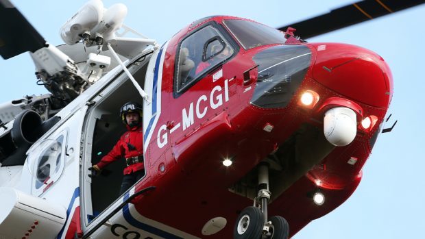 A coastguard helicopter is involved in the rescue effort