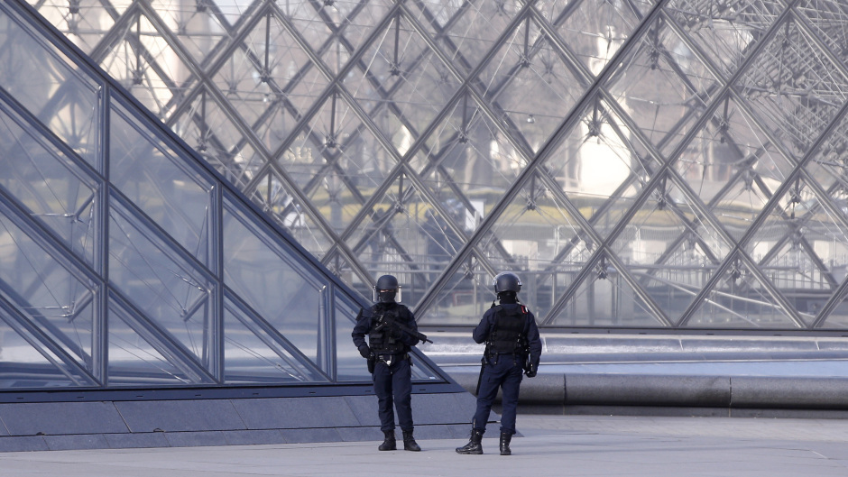 Police officers patrol at the pyramid outside the Louvre in Paris (AP/Thibault Camus)