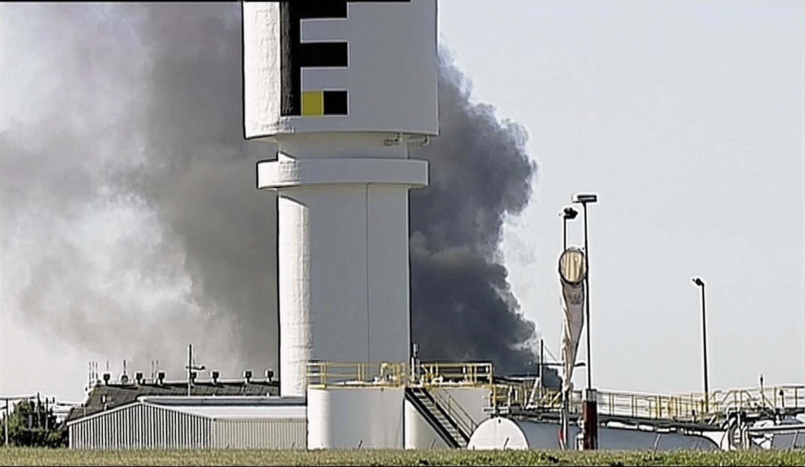 In this image made from video, smoke billows from the site of a plane crash at Essendon Airport in Melbourne, Australia 