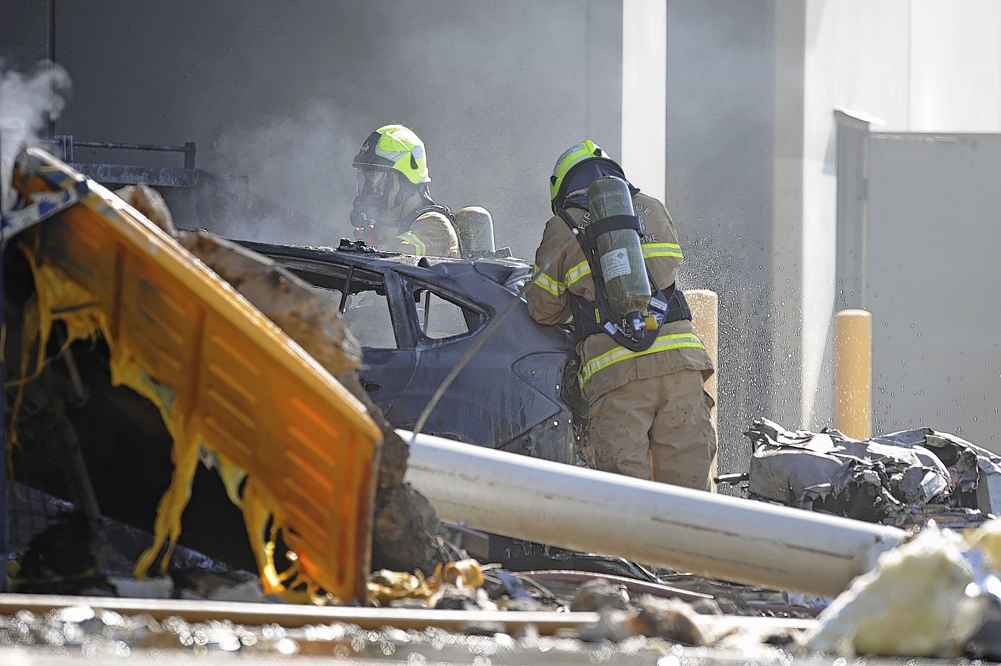 Emergency personnel work at a light plane crashed in Melbourne, Australia