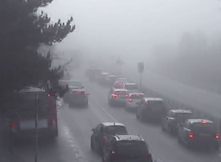 A foggy road full of Traffic Scotland