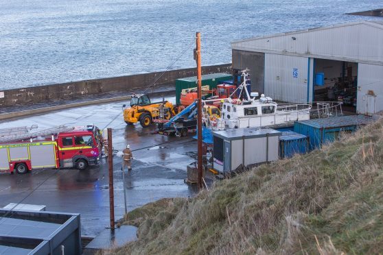 Firefighters at the warehouse at Wick Harbour