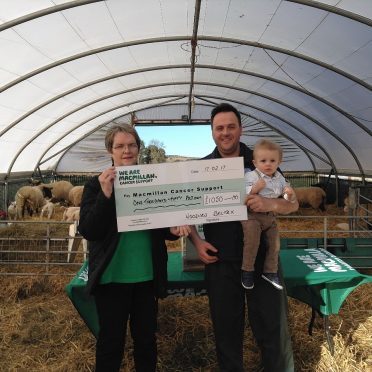 Margo Stewart receiving a cheque from Stuart and Murray Wood