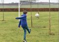 One pupil scores on the newly planted football pitch at Logie Durno