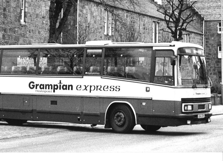 A Grampian Transport coach leaves the depot in King Street