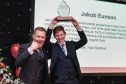 Jakob Eunson, right, collecting his prize from Adam Henson.