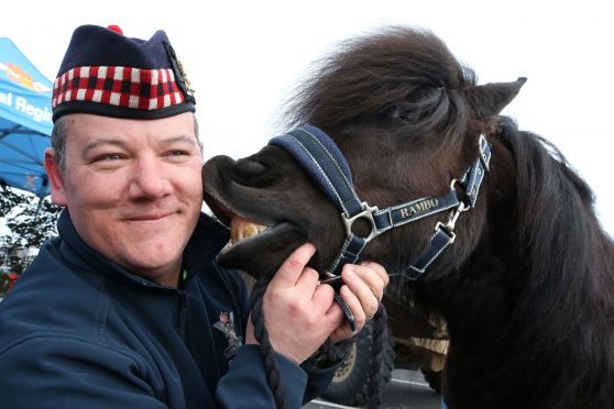 Lance Corporal Cruachan IV, the Shetland Pony mascot of the Royal Regiment Scotland, with Pony Major Mark Wilkinson at the Tesco store in the Eastfield retail park, Inverness