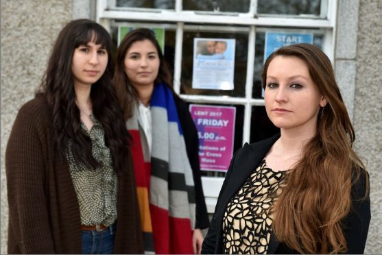 University of Aberdeen students Randi Morse, Carloto Demony and Jasmin Moussapacha are upset at pro-abortion posters in The Universities' Catholic Chaplaincy window at Old Aberdeen, High Street.
Picture of (L-R) Jasmin Moussapacha, Carloto Demony, Randi Morse.
Picture by KENNY ELRICK