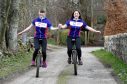 Fundraisers Iona Copley and Gemma Shaw on their unicycles.