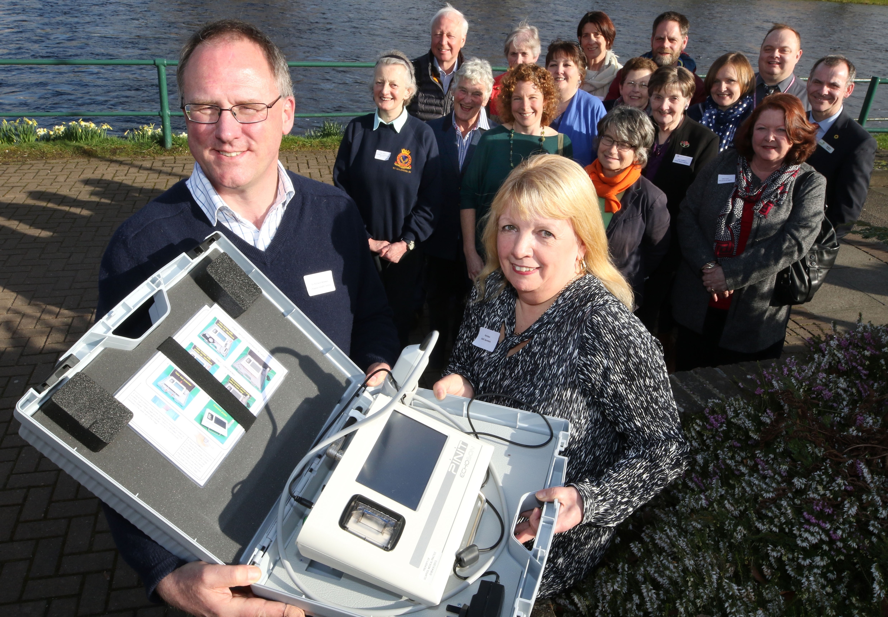 Representatives of the charities with, at the front, Ullapool Health Centre GP Richard Weekes and Great Wilderness Challenge secretary Pat Ross, with a £6,000 ultrasound scanner donated to the health centre.