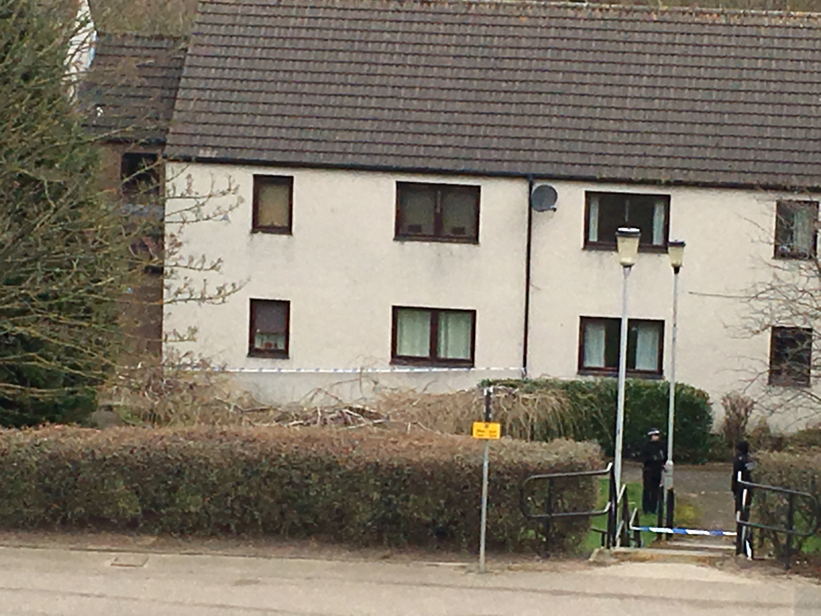 Police stand guard outside the flats in Aberdeen