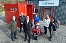 Wesubsea UK handed over a container to house Kemnay's flood defence equipment. Residents and members of the community council, (from left) Bob Ingram, Mark Mellor, RAM, Jason Wilson, Wesubsea, Gordon and Liz McKinstry with grandson Oliver, 2 and dog Kiera, Linda Kain and Irene Ferguson. Picture by Colin Rennie.