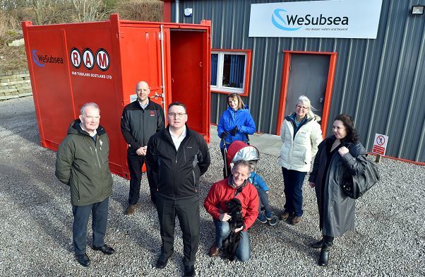 Wesubsea UK handed over a container to house Kemnay's flood defence equipment. Residents and members of the community council, (from left) Bob Ingram, Mark Mellor, RAM, Jason Wilson, Wesubsea, Gordon and Liz McKinstry with grandson Oliver, 2 and dog Kiera, Linda Kain and Irene Ferguson. Picture by Colin Rennie.
