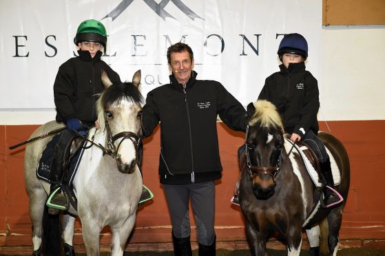 Sir Mark Todd flanked by Lewis Lawson, left, and Millie Lawson on the right.