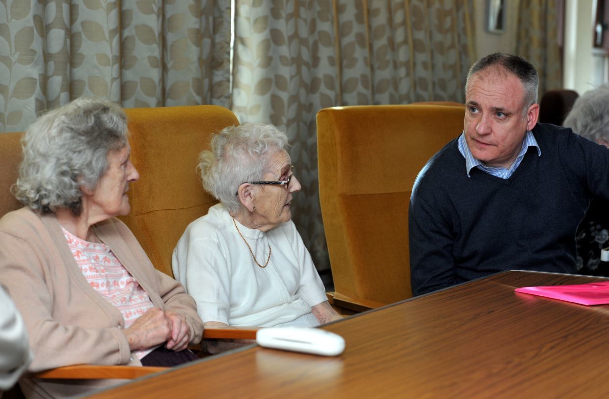 Larch Court residents, Jenny MacNicol and Marjorie Green, quizzing Richard Lochhead MSP about the bus timetable changes.