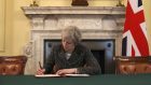 Prime Minister Theresa May in the cabinet signs the Article 50 letter, as she prepares to trigger the start of the UK's formal withdrawal from the EU on Wednesday.