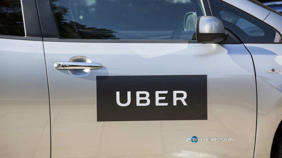 'Uber' sign on the side of a car.