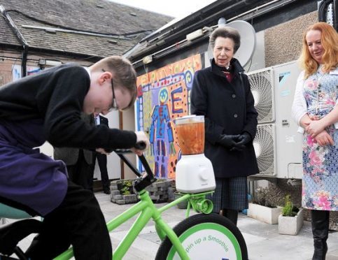 Connor Mcnulty, 12, demonstrates the pedal-powered smoothie maker for the Princess Royal.