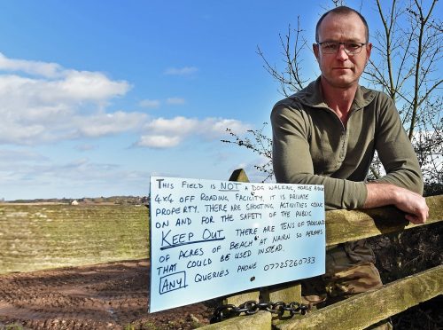 Auldearn farmer Craig Philip and his sign.