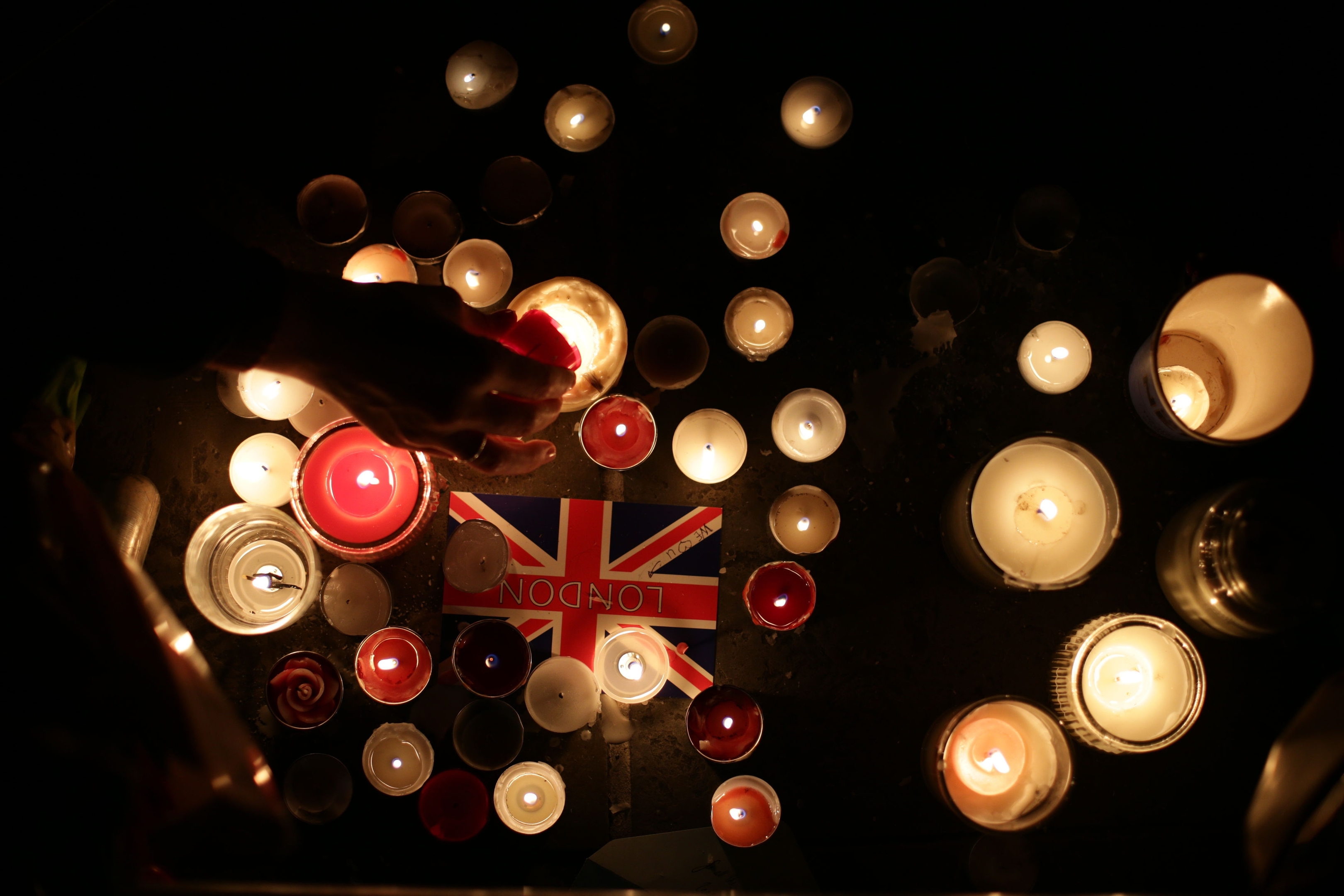Members of the public light candles during the vigil in Trafalgar Square, London to remember those who lost their lives in the Westminster terrorist attack.