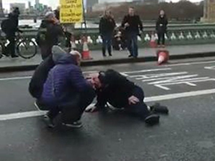 Screengrab from a video posted on the twitter feed of @sikorskiradek of people attending to a person on Westminster Bridge, London following the incident