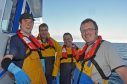 Members of the crew of the Shetland whitefish boat Guardian Angell wearing their PFDs