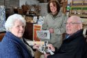 Iris Garden, pictured left, and her brother John Gill were reunited with the pictures yesterday at Debbie Wright's Burghead workshop.