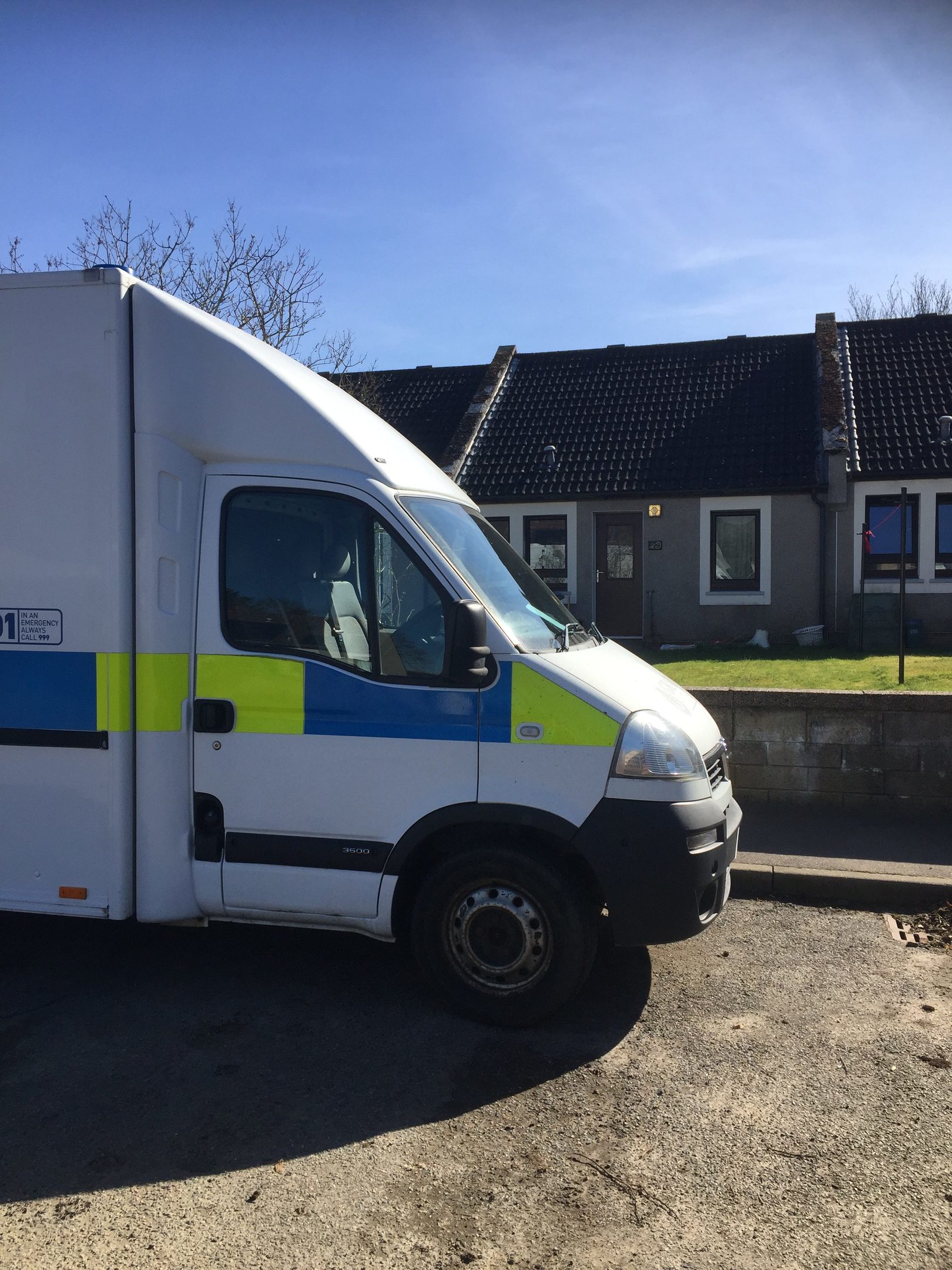 A police van stands guard outside the property at St Andrew's, Monymusk