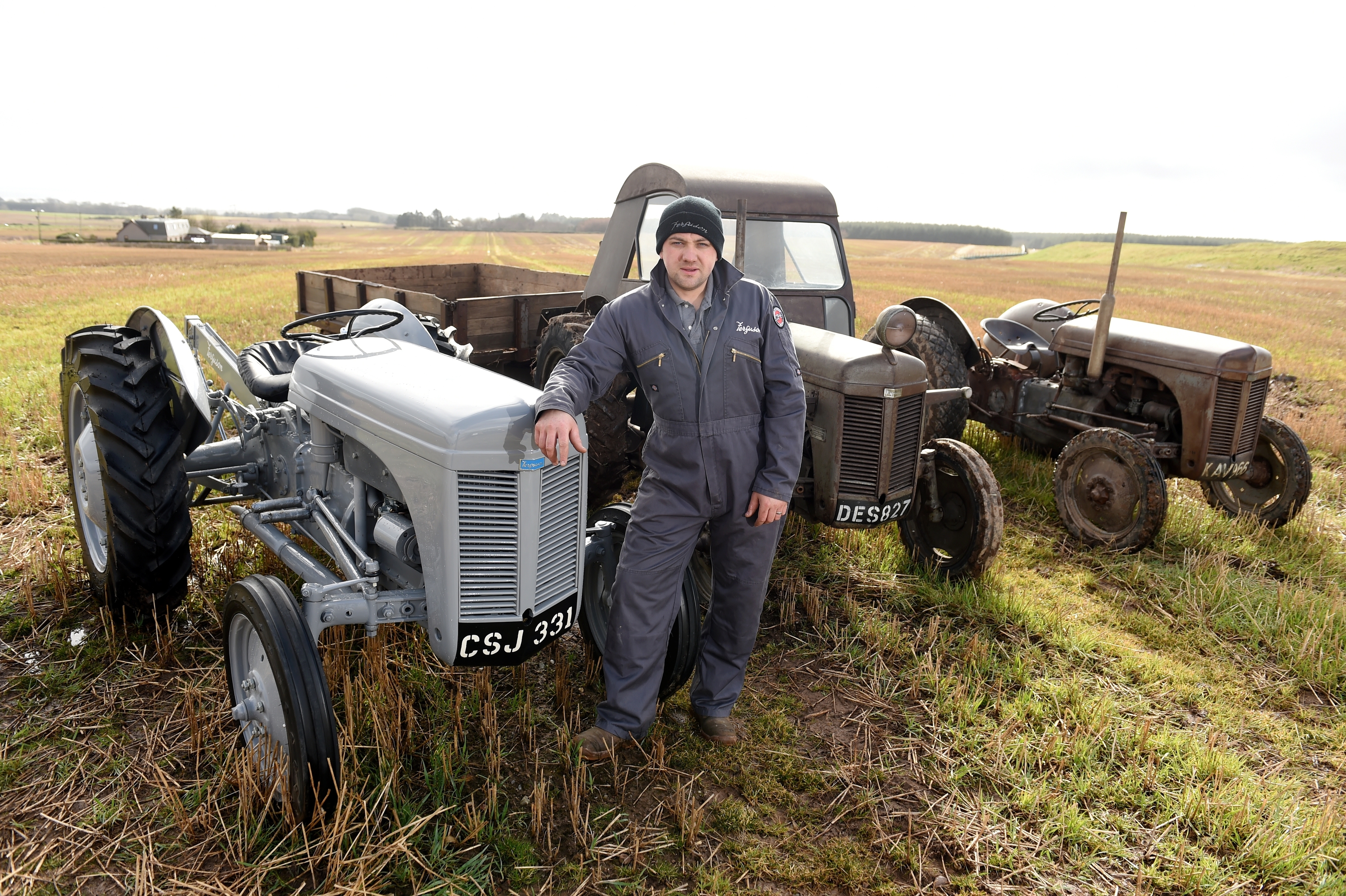 Gary Norrie with several of his vintage tractors