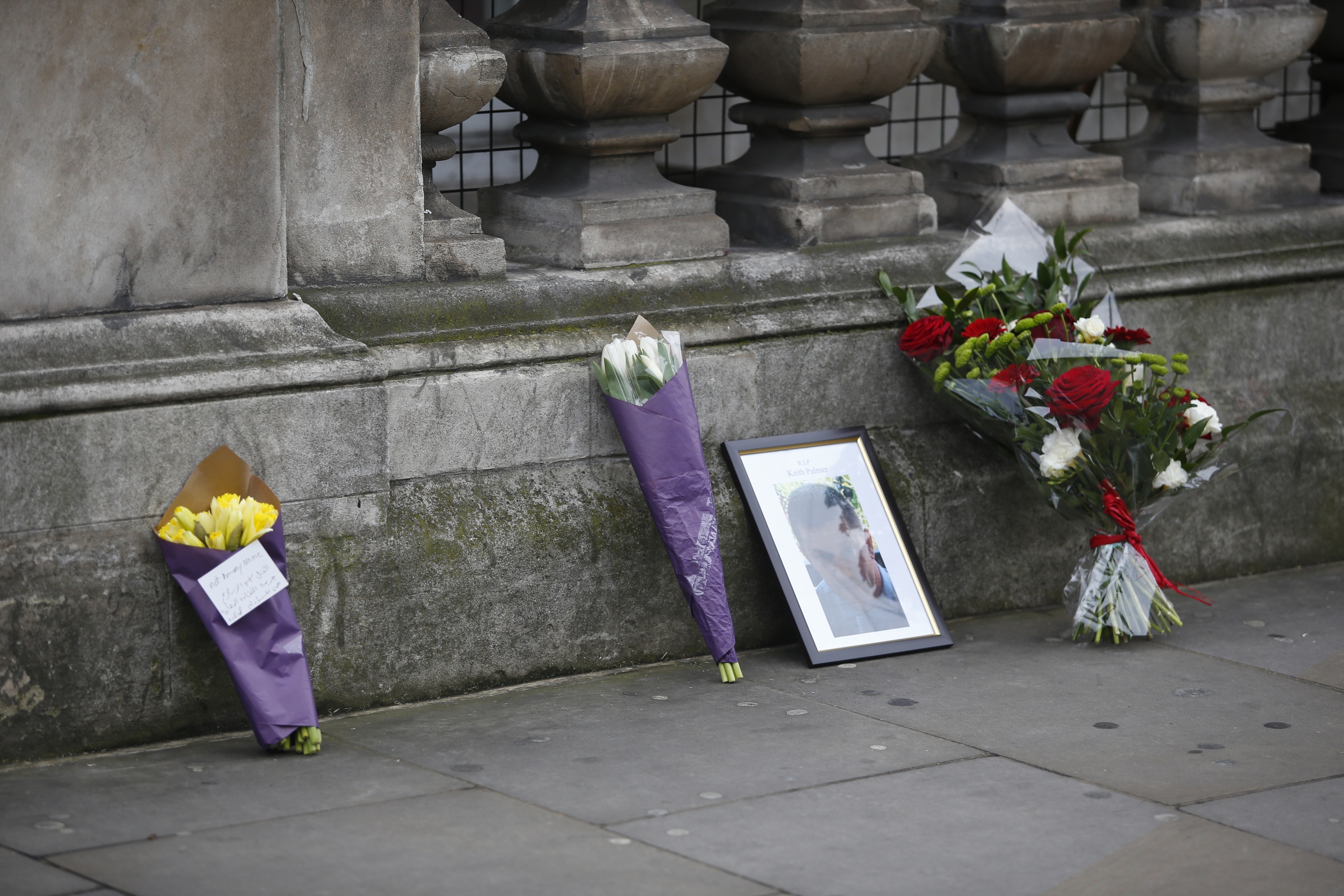 Floral tributes and a framed photograph in Whitehall following yesterday's attack