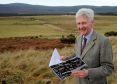 John Grant of Rothiemurchus Estate with the site of the proposed An Camus Mor development at the rear in the far distance.
