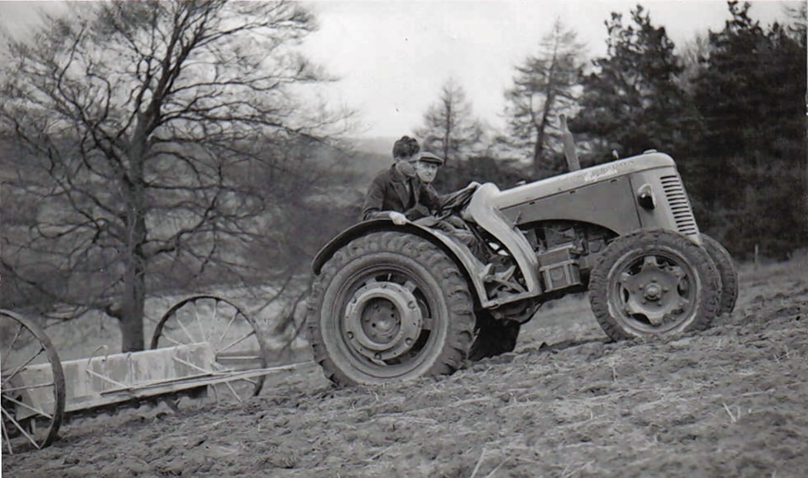A David Brown Cropmaster spreading fertiliser on steepish ground.