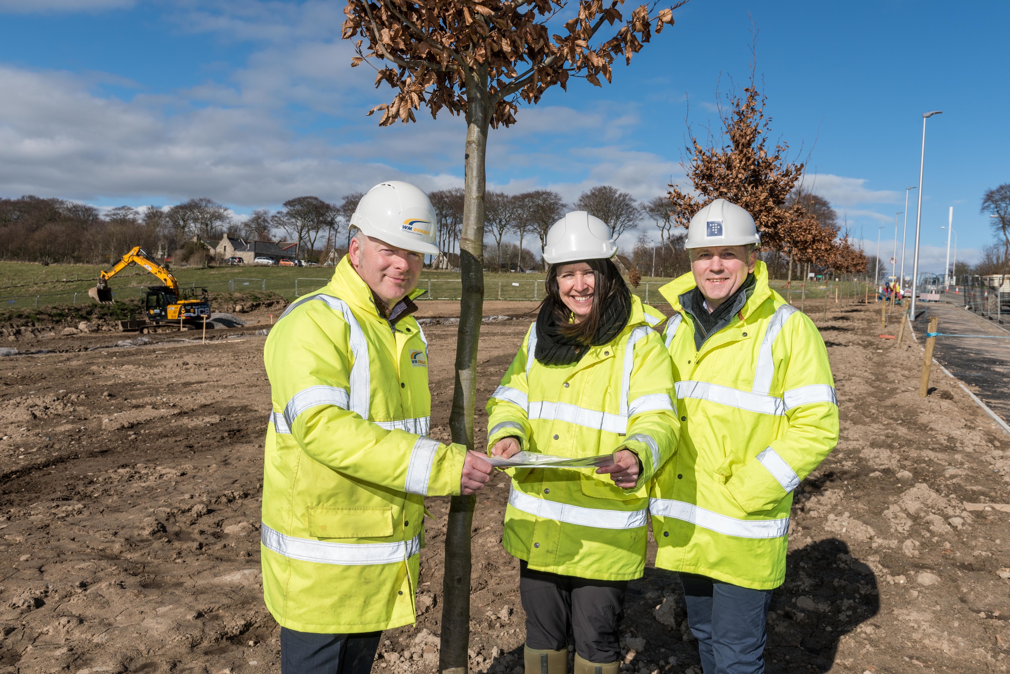 Ian Downie of principal contractor WM Donald, Laura Scott-Simmons of landscape architects Benton Scott-Simmons and Gordon Rendall of project managers Turner & Townsend at the new community of Grandhome, where more than 1,200 trees are being planted in the first phase of development.