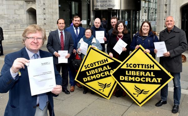 The Liberal Democrats held their manifesto launch outside Marischal College in Aberdeen. Leader Iain Yuill with (from left) Martin Greig, Cameron Finnie, Dorothy Pearce, Gregor McAbery, Steve Delanay, Jennifer Stewart, Jenny Wilson and Ken McLeod.
Picture by Colin Rennie.