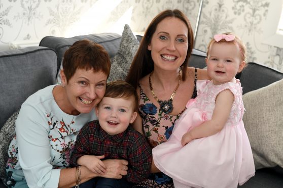 Model Milly Hutcheon at home in Kincorth with her daughter Elaine and grandchildren Finlay and Louisa.    
Picture by Kami Thomson.