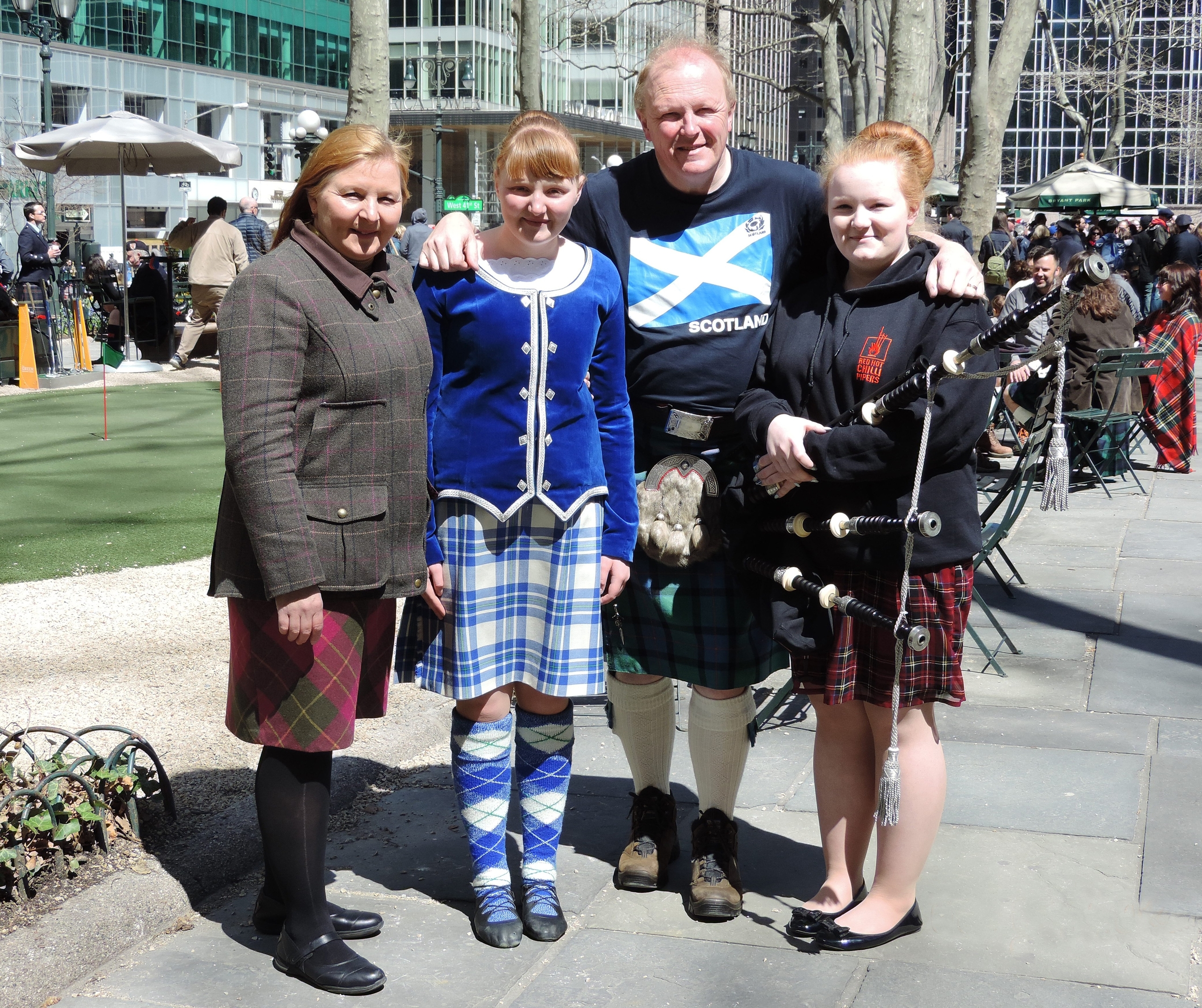 Elizabeth (right) played the bagpipes during the New York Tartan Day Parade, while her younger sister Anna performed with the New York Highland Dancers. Pictured here with their parents.